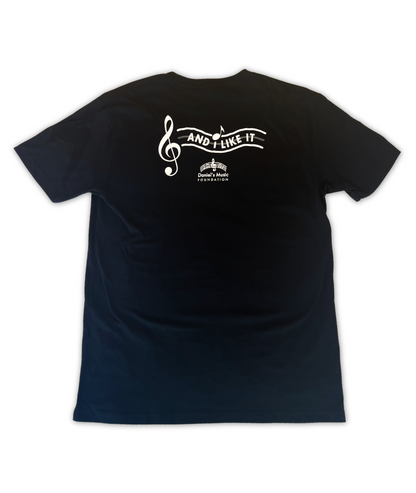 Rear image of a black t-shirt, featuring the stylized wavy text reading "And I like it" next to a large treble clef on the left.