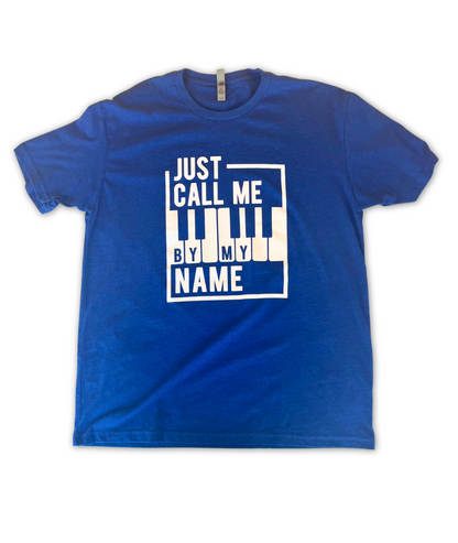 Image of a red t shirt with the words "Just call me by my name", stylized around a bordered piano keyboard